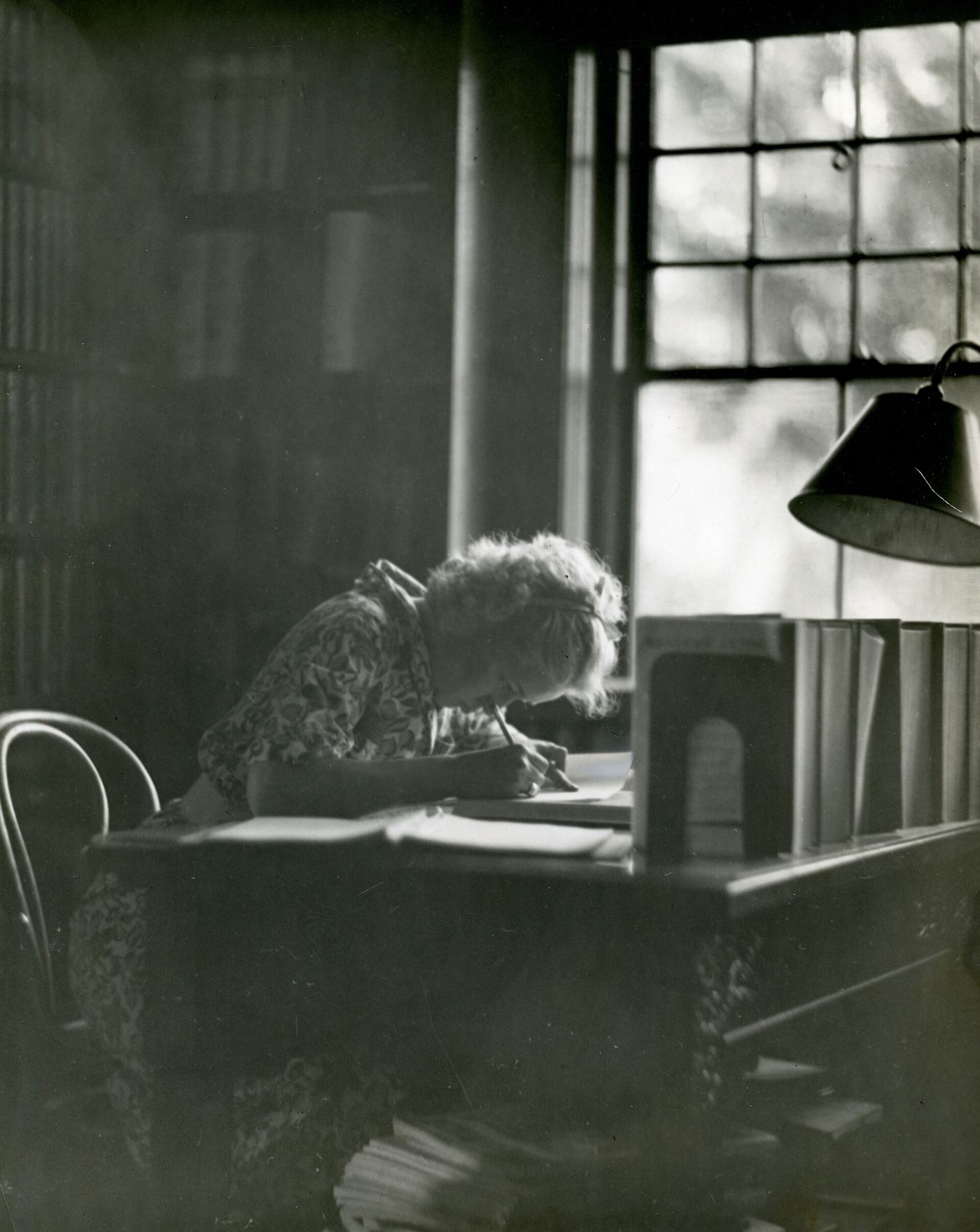 A student studying at a desk with handwritten notes and a neat stack of flashcards.