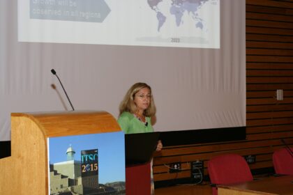 Lecturer presenting slides on a projection screen in a seminar room