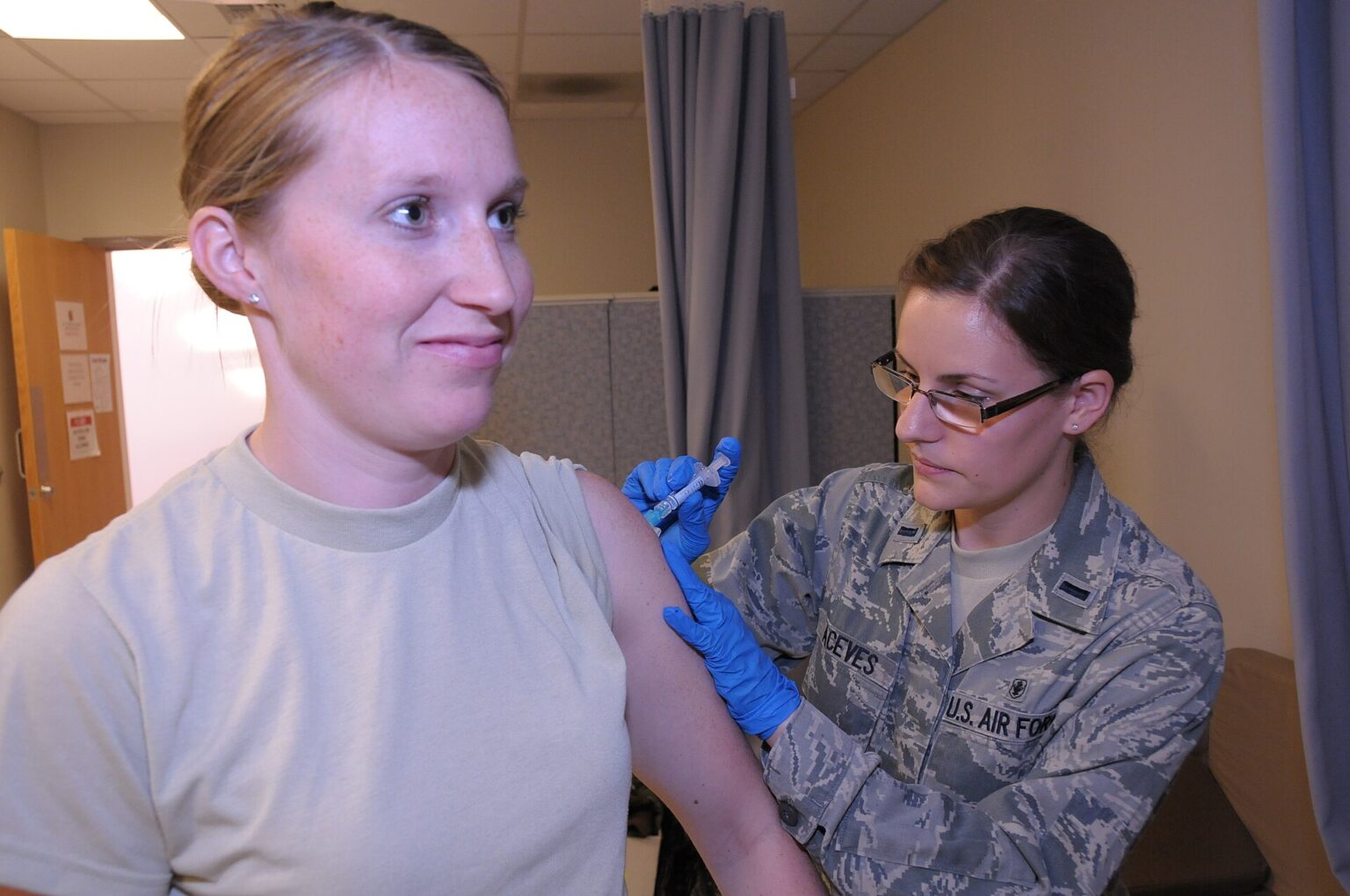 A nurse preparing a measles vaccine dose in a health clinic