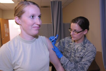 A nurse preparing a measles vaccine dose in a health clinic
